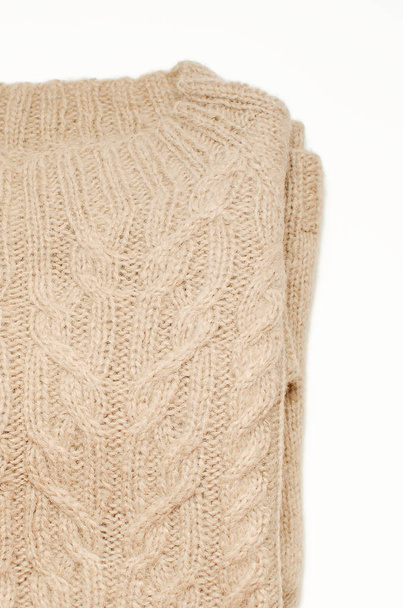 Fashionable beige knitted jumper with a beautiful pattern, close-up. - Foto, Imagem
