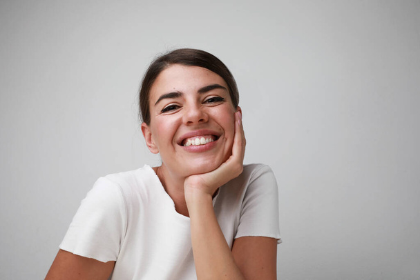 Portrait of happy young caucasian woman, smilling posing over white background. - Foto, immagini