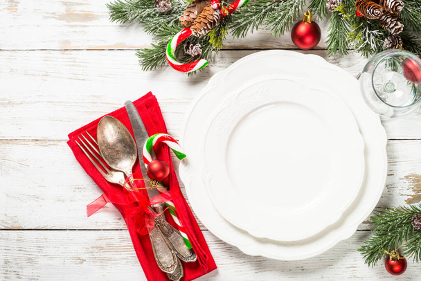 Christmas table setting with holidays decorations at white wooden table. - Foto, afbeelding