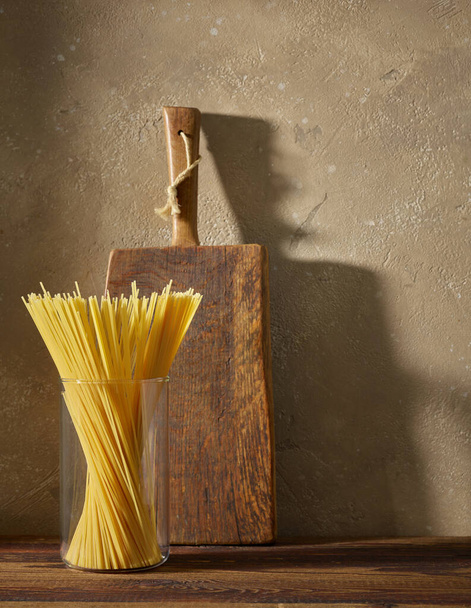spaghetti pasta on brown kitchen wooden shelf - Foto, imagen