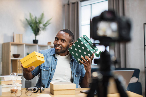 Male influencer doing live stream while opening presents - Foto, immagini