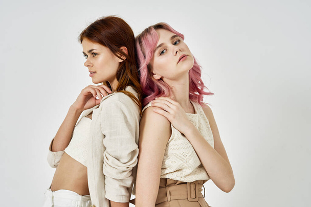 two girlfriends stand side by side fashion clothing glamor posing - Fotografie, Obrázek