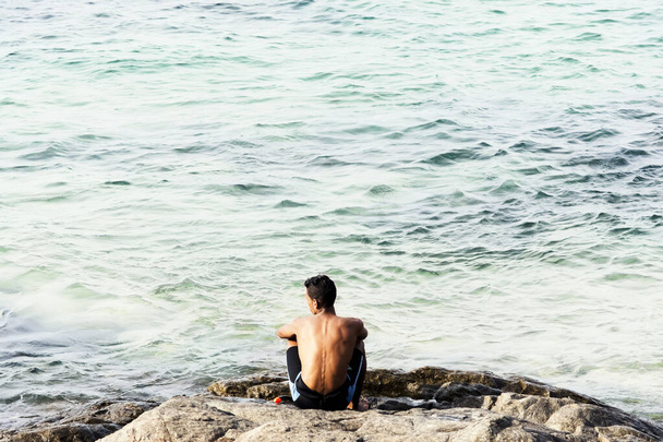 Salvador, Bahia, Brazil - January 08, 2019: A man looking at the sea at Porto da Barra beach in Salvador, Bahia, Brazil. - Photo, Image
