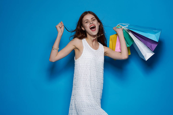 smiling woman with packages in hands Shopaholic isolated background - Zdjęcie, obraz