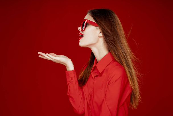 beautiful woman wearing sunglasses red shirt makeup isolated background - Fotoğraf, Görsel