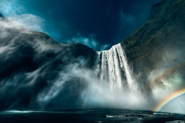 A low angle shot of the Skogafoss waterfall in Iceland - Fotó, kép