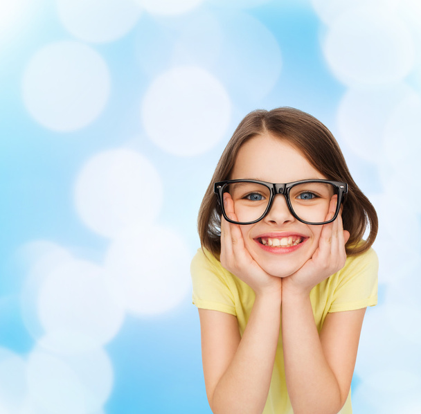 smiling cute little girl in black eyeglasses - Foto, imagen