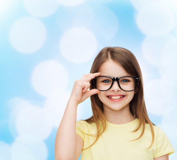 smiling cute little girl in black eyeglasses - Photo, image