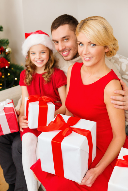 smiling family holding many gift boxes - Foto, Bild