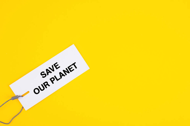 A tag with a written text "save our planet" on yellow background - Φωτογραφία, εικόνα
