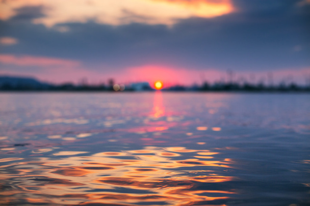 Захід сонця світло, що сяє на океанічній хвилі з помаранчевими тонами
 - Фото, зображення