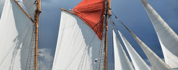 An elegant two-masted gaff schooner (training tall ship). Travel, history, traditions, transportation, sailing, sport, cruise, regatta, teamwork. Panoramic view - Photo, Image