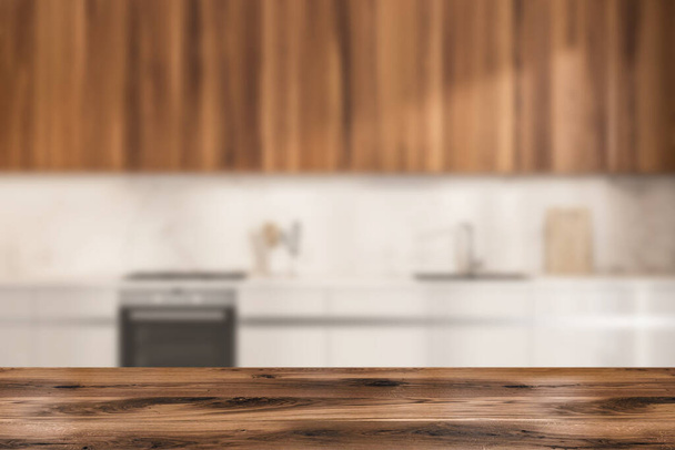 Wooden desk on foreground, blurred white cooking interior with table, sink and oven, kitchenware and appliances. Mockup for display of product, 3D rendering - 写真・画像