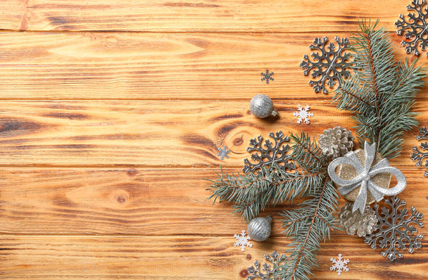 Beautiful snowflakes, Christmas decor and fir branches on wooden background - Photo, Image