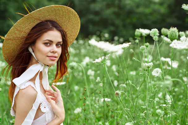 Woman with hat white dress flowers nature relaxation - Φωτογραφία, εικόνα