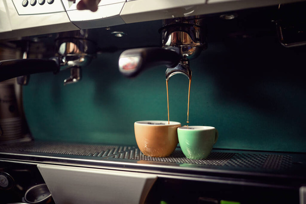 Close-up view of an espresso apparatus making aromatic and fragrant beverage. Coffee, beverage, bar - 写真・画像