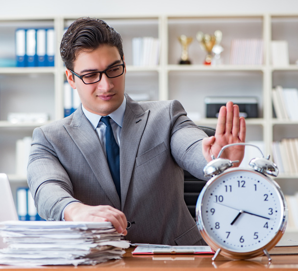 Young businessman in time management concept - Photo, Image