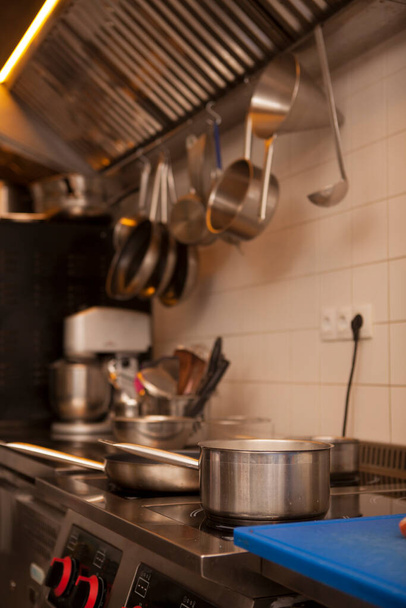 Vertical shot of a boiling pot on the stove at the restaurant - Fotografie, Obrázek