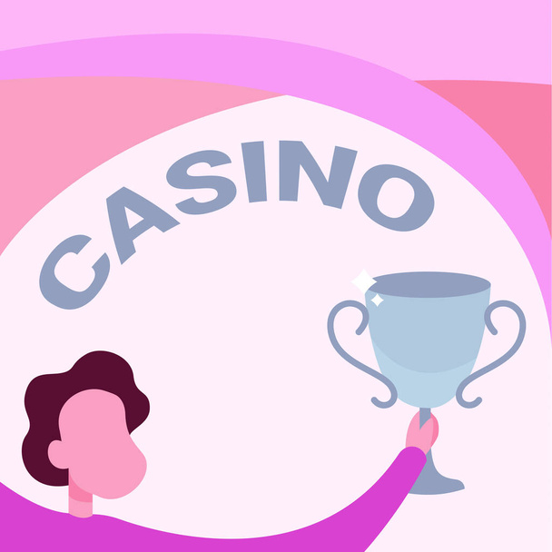 Text sign showing Casino. Conceptual photo a building where games especially roulette and card games are played Man Holding Trophy Cup Up High Celebrating Victory Achievement. - Photo, Image