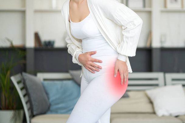 Hip pain, woman suffering from osteoarthritis at home, health problems concept - 写真・画像