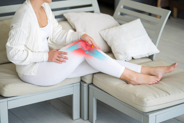 Knee pain, woman suffering from osteoarthritis at home, chiropractic treatments concept - Valokuva, kuva
