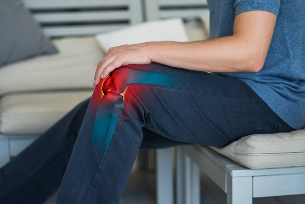 Knee pain, man suffering from osteoarthritis at home, chiropractic treatments concept - Valokuva, kuva