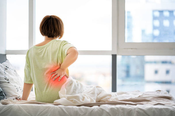 Back pain, kidney inflammation, woman suffering from backache at home, health problems concept - Foto, Imagem