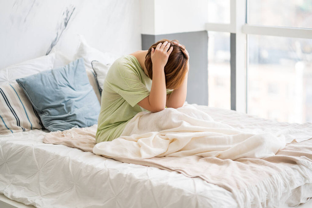 Headache and migraine, woman with head pain in home interior, health problems concept - Foto, Bild