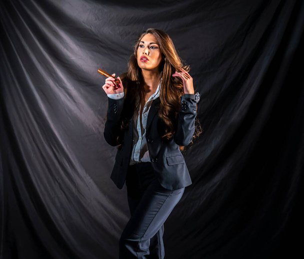 A beautiful mixed race model poses in a business suit in a studio environment - Foto, Bild