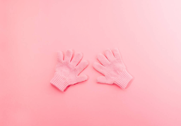 Soft pink glowes on a pink background. Winter minimal flat lay concept. - Photo, Image