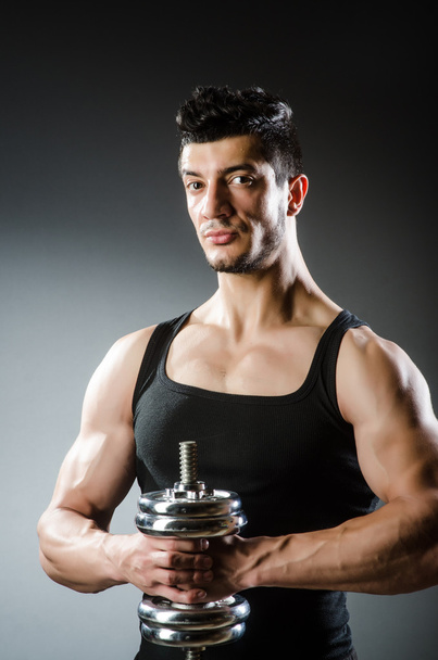 Muscular ripped bodybuilder with dumbbells - Photo, Image