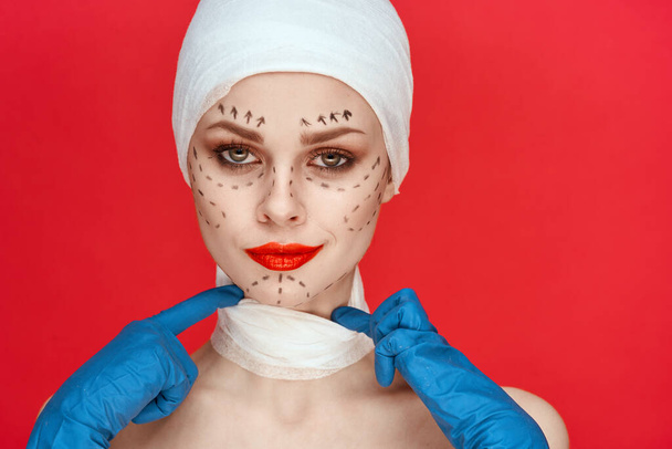 a person Red lips plastic surgery operation bare shoulders red background - Valokuva, kuva