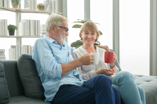 Happy Caucasian seniors couple are drinking coffee in home , relaxing and health care concept . - Foto, imagen
