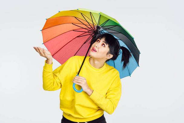 woman with multicolored umbrella fun posing fashion - Foto, imagen