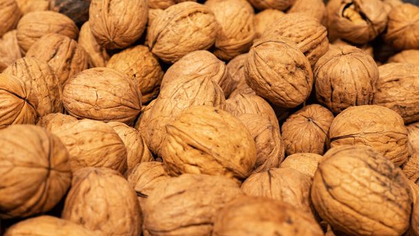 Heap of whole walnuts - full frame natural pattern background detail. - Foto, Imagen