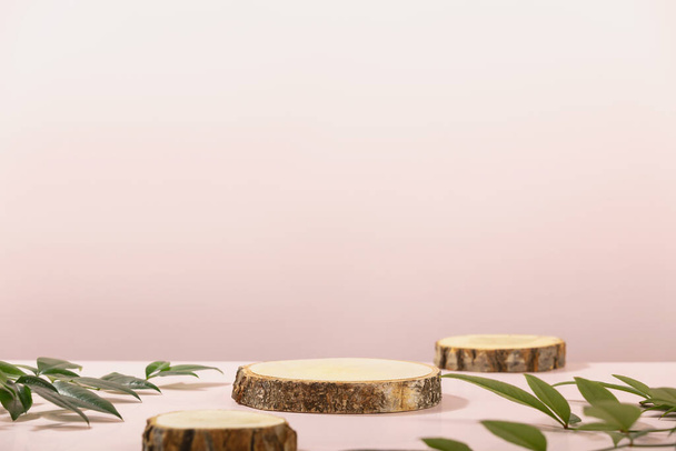 Wood slice podiums on pink background for cosmetic product mockup - Foto, imagen