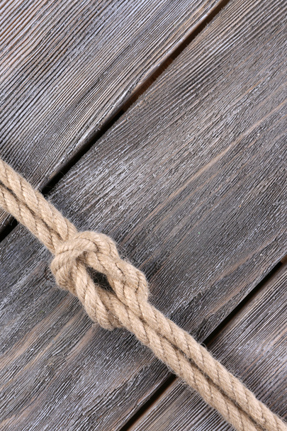 Marine knot on wooden background - Foto, Imagen