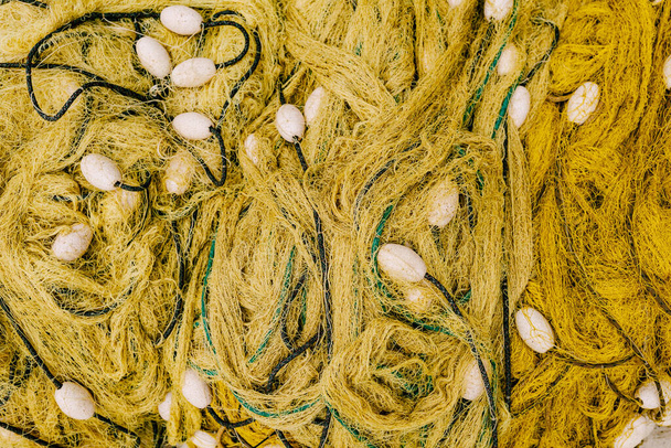 Yellow fishing net with floats. Close-up - Photo, Image