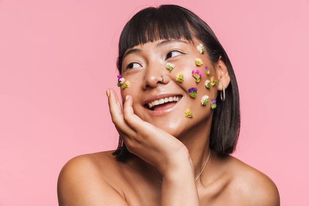 Beauty portrait of a smiling happy young brunette asian woman with makeup facial decoration over wall background - Φωτογραφία, εικόνα