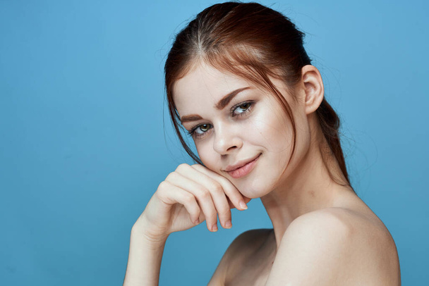 woman with bared shoulders pigtail emotions posing blue background - Foto, Imagem