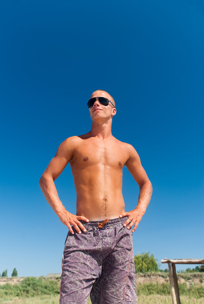 Image of a young masculine man posing at the beach - Photo, image
