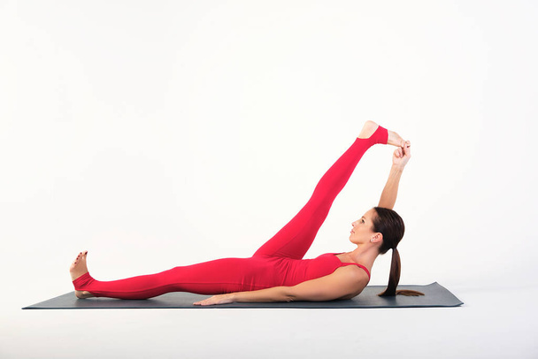 charming yoga instructor shows how to do asanas correctly - Fotografie, Obrázek