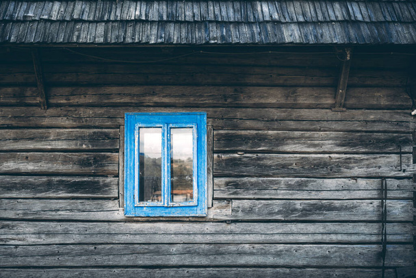 Wooden house wall with wooden roof and cyan blue window - Fotoğraf, Görsel