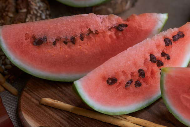 Fresh juicy slices of watermelon appetizing. Light dessert, healthy food. Filming food. - Photo, image