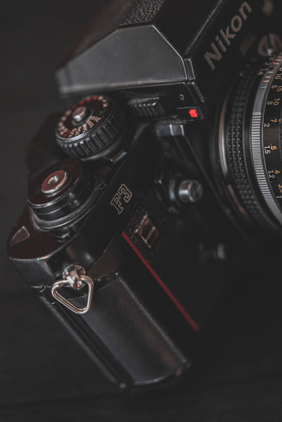 PERTH, AUSTRALIA - Oct 28, 2021: A close-up shot of a part of a Nikon Film Camera with a rustic look on a dark background - Fotografie, Obrázek