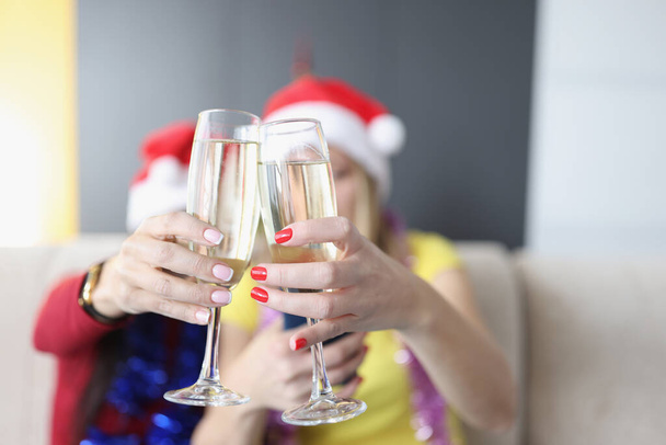 Women hold champagne drinks, glass filled with alcohol, raise toast for new year coming - Photo, Image