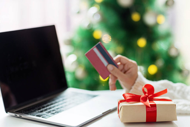 Young woman Paying online with credit card, holiday shopping. Person using technology - Foto, immagini