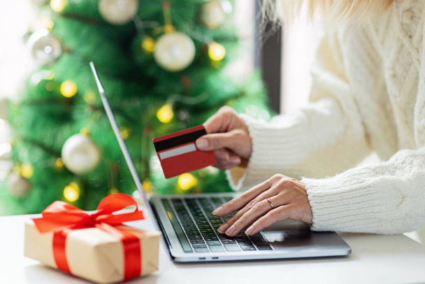 Young woman Paying online with credit card, holiday shopping. Person using technology - Fotografie, Obrázek