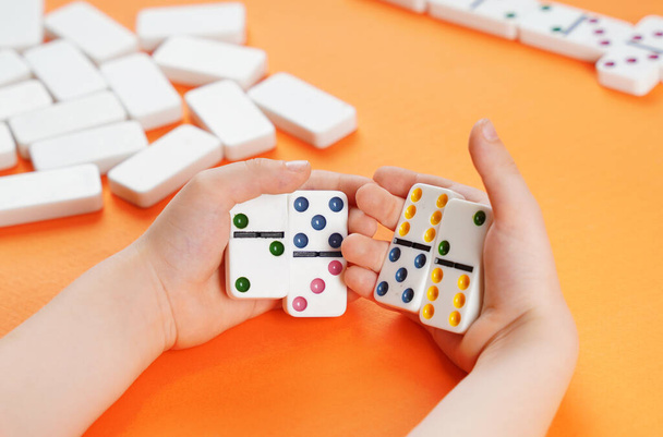 Domino game. Dominoes in children's hands. - Foto, Bild