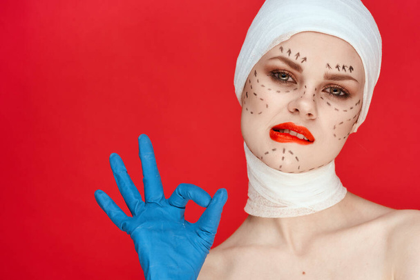 female patient Red lips plastic surgery operation bare shoulders red background - Photo, image